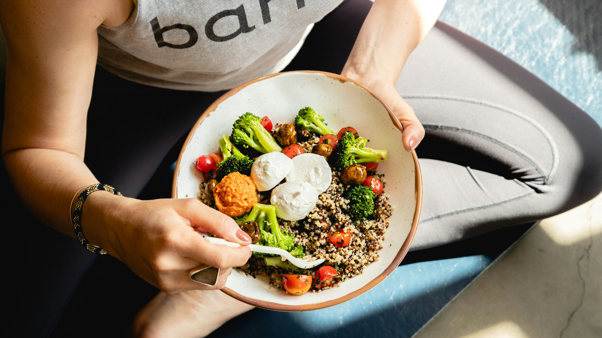 A colorful bowl of fresh whole foods on a light background, suggesting mindful eating